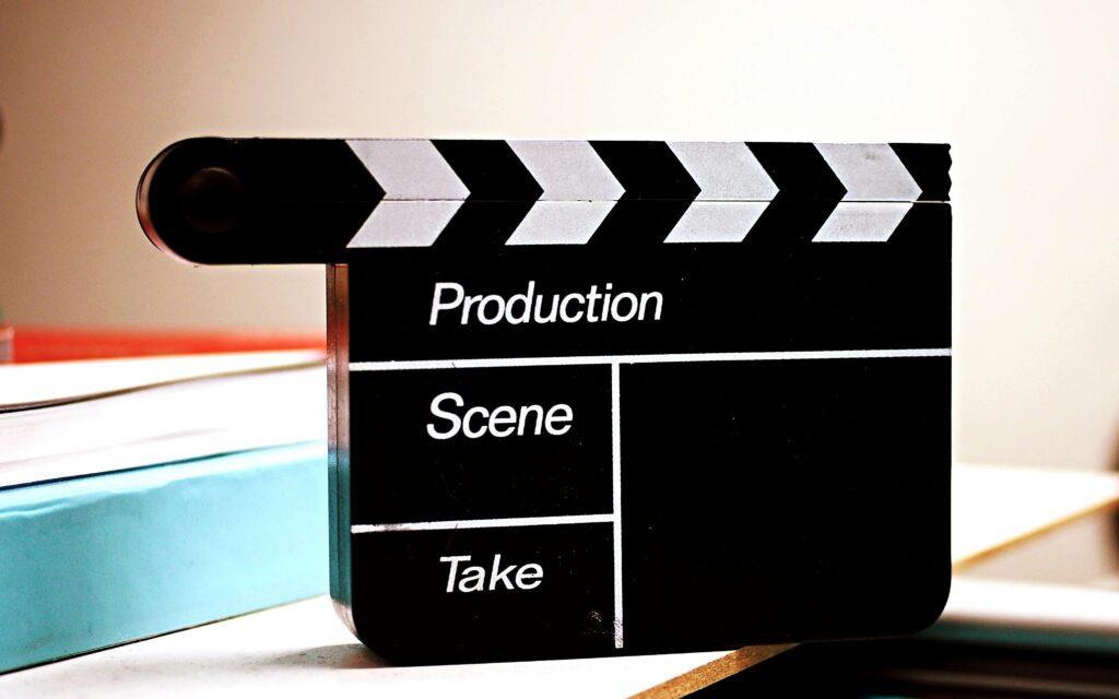 Close-up of a film clapperboard on a desk, ideal for media and production themes.